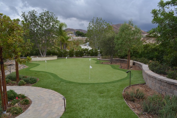 Metro New York Synthetic grass golf green in a landscaped backyard