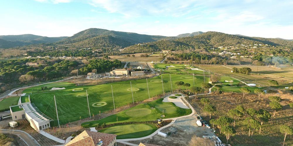 Metro New York Aerial view of a synthetic grass golf course surrounded by hills